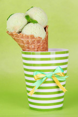 Appetizing pink ice cream with waffle cone in cup