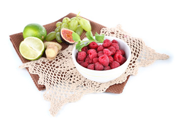 Raspberries in small bowl on napkin isolated on white