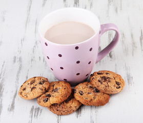 Cocoa drink and cookies on wooden background