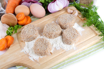 Meat patties on board on napkin  isolated on white