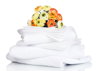 Stack of clean bedding sheets and towels isolated on white