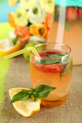 Basil lemonade with strawberry in  jug and glass,