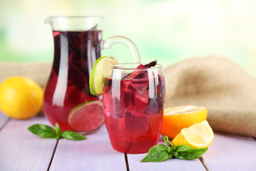 Red basil lemonade in jug and glass,