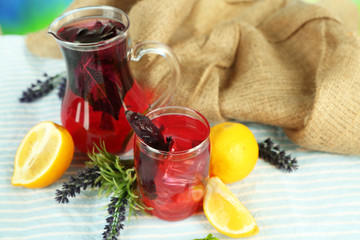 Red basil lemonade in jug and glass,