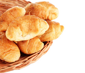 Tasty croissants on wicker mat isolated on white