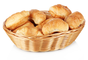 Tasty croissants in wicker basket isolated on white