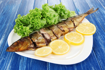 Smoked fish on plate close up