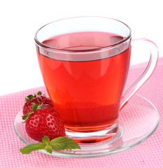 Delicious strawberry tea on table on white background