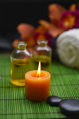 Spa setting with orchid and towel with massage oil