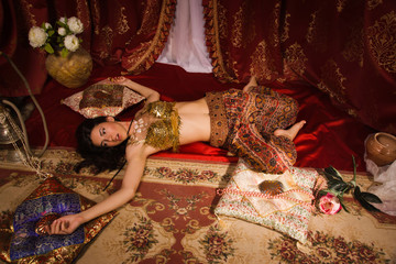 Crime scene imitation: lifeless woman in oriental costume lying