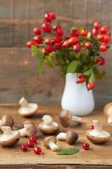 Fresh mushrooms  and briar on wooden  background