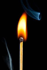 burning match with smoke, black background