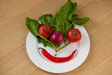 Vegetable face on a white plate