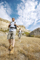 Adult man and woman are hiking