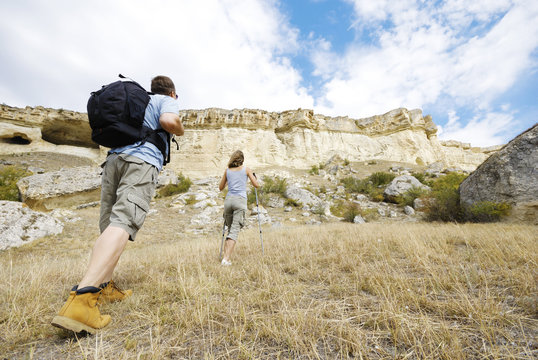 Adult Man And Woman Are Hiking