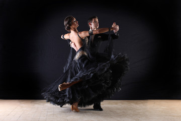 Latino dancers in ballroom isolated on black