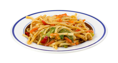 A meal of noodles and vegetables on a small dish