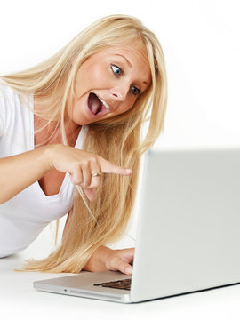 Surprised woman pointing at her laptop