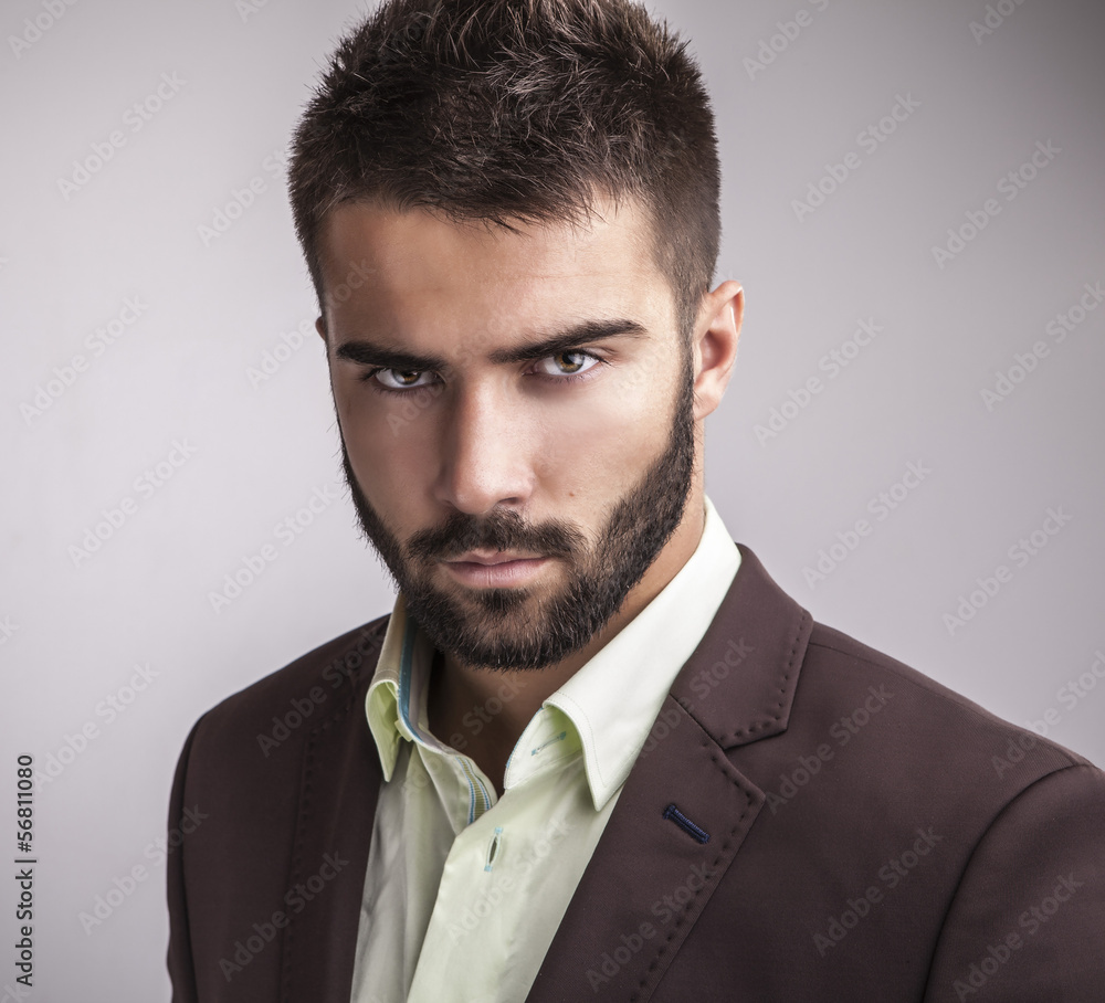 Wall mural Elegant young handsome man. Studio fashion portrait.