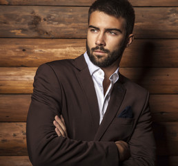 Young beautiful fashionable man against wooden wall. - 56811437