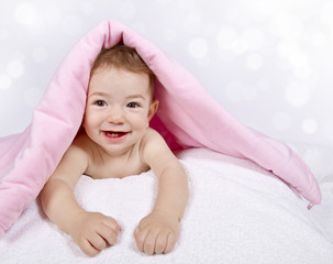 Little girl with pink blanket on head