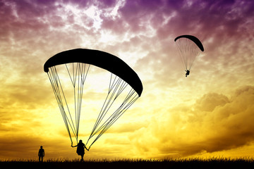 Paragliding at sunset - obrazy, fototapety, plakaty