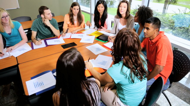 Male Female Teenage Students Working Towards Degree