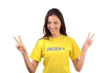 Girl signing victory for Sweden, flag on her yellow t-shirt.