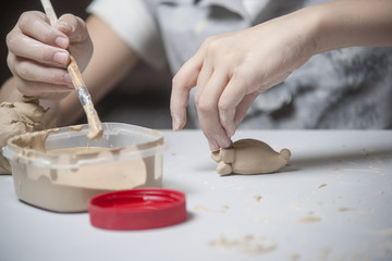 Girl make toyfrom clay