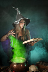 Halloween witch cooking a potion in a cauldron