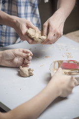 Girl make toyfrom clay