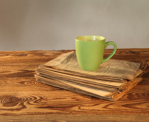 Cup of tea with newspaper on wood