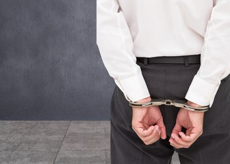 Close up on young businessman wearing handcuffs