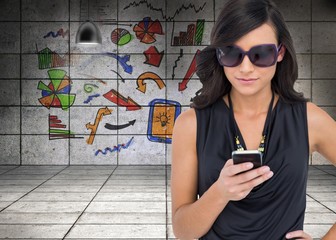 Concentrated brunette wearing sunglasses texting