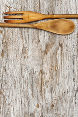 Kitchen utensils on the old wood background