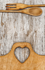 Kitchen utensils on the old wood background