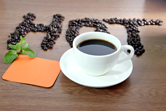 Fototapeta White coffee cup and paper note orange lettering that hot.