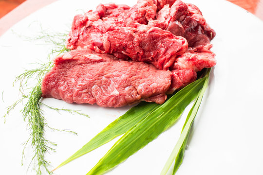 closeup of some raw beef fillets  on a white background