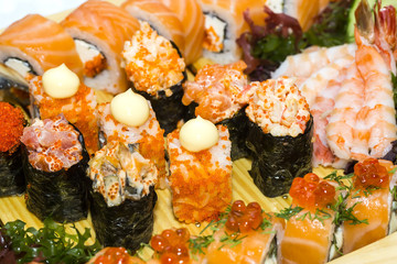 Japanese rolls in a restaurant with fish and vegetables