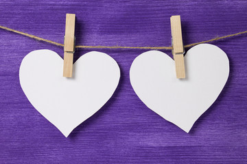 two paper hearts hanging on rope