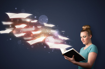 Young lady reading a book with flying sheets coming out of the b