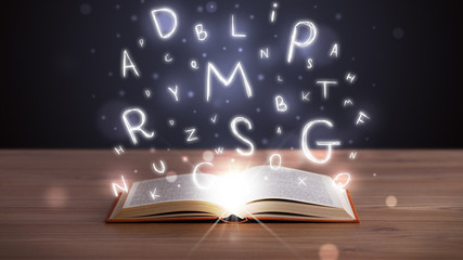 Open book with glowing letters flying out