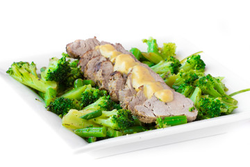 Baked, sliced fillet of pork with green vegetables, broccoli