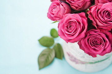 Bouquet of beautiful pink roses on light blue background.