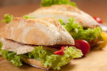 Tasty sandwiches with vegetables on a wooden table.