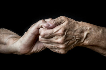 old hands on a black background