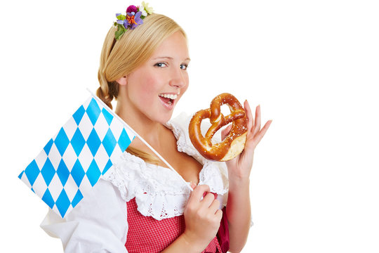 Woman with bavarian flag eating pretzel