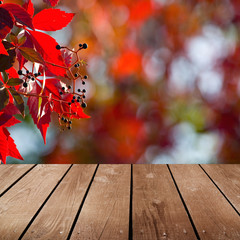 empty wooden deck table and red ivy.