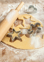 Baking christmas cookies - dough, cookie cutters and rolling pin