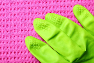 Pink sponge and green rubber glove